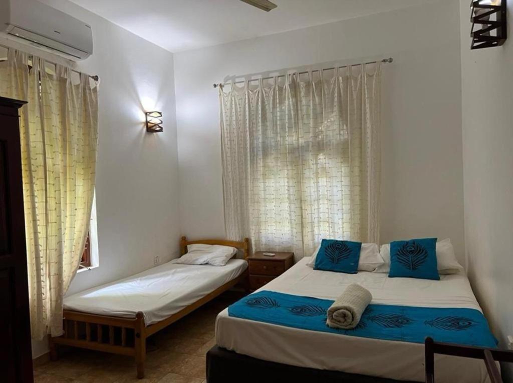 Postel nebo postele na pokoji v ubytování Manik Villa