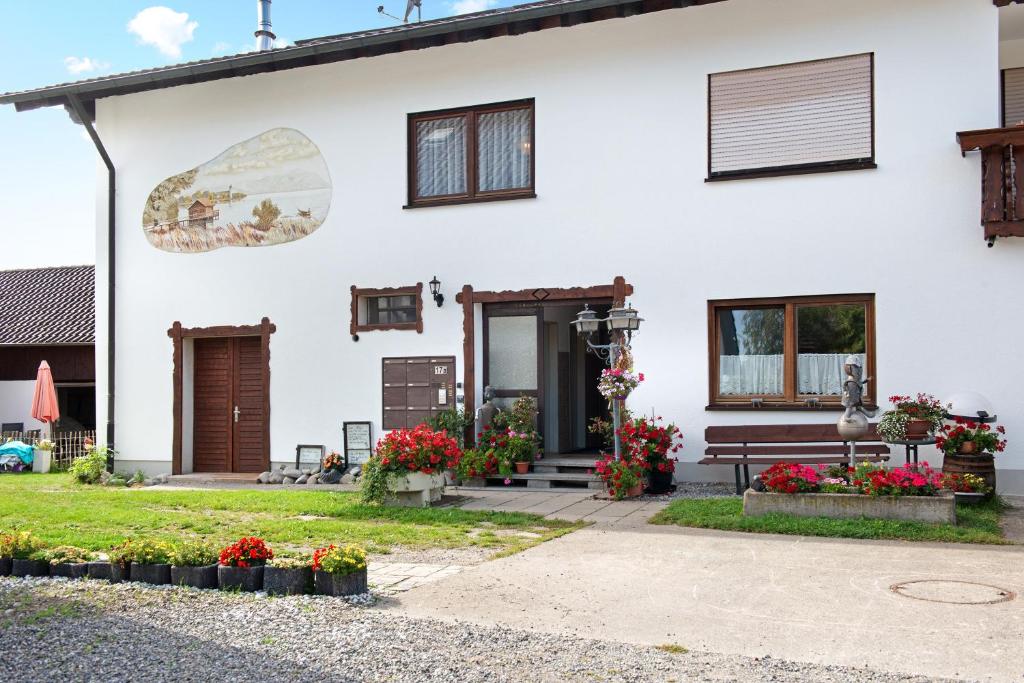 a white house with flowers in front of it at Ferienwohnungen Sernatinger in Überlingen