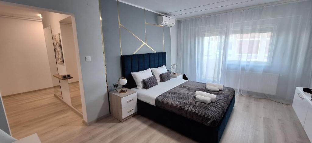 a bedroom with a large bed and a window at Riverside 1 in Timişoara