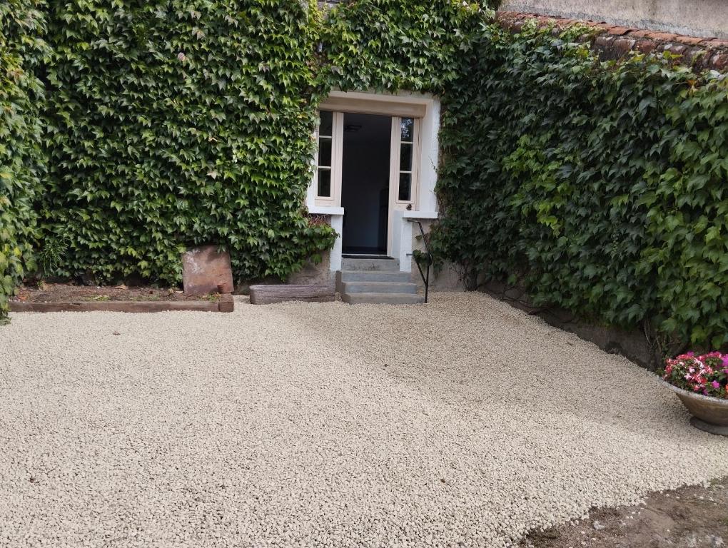 a house with a door and a plant at Maison au calme avec vue étang in Clessé