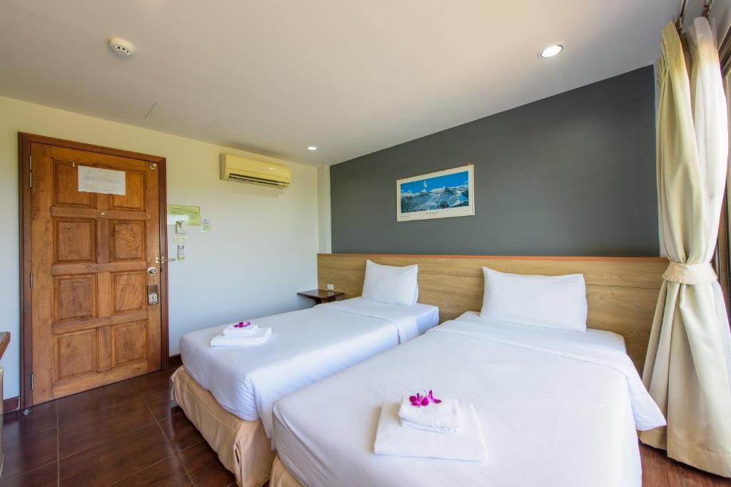 Postel nebo postele na pokoji v ubytování Baan Grood Arcadia Resort & Spa