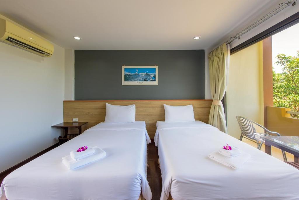 Postel nebo postele na pokoji v ubytování Baan Grood Arcadia Resort & Spa