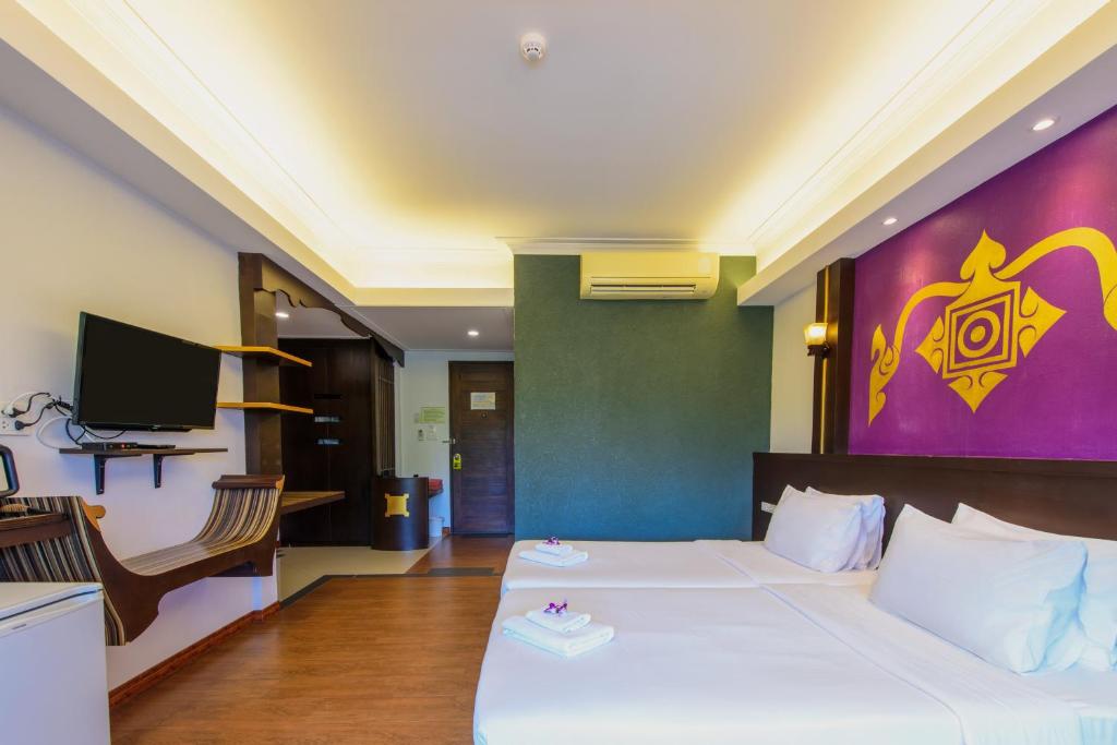 Postel nebo postele na pokoji v ubytování Baan Grood Arcadia Resort & Spa