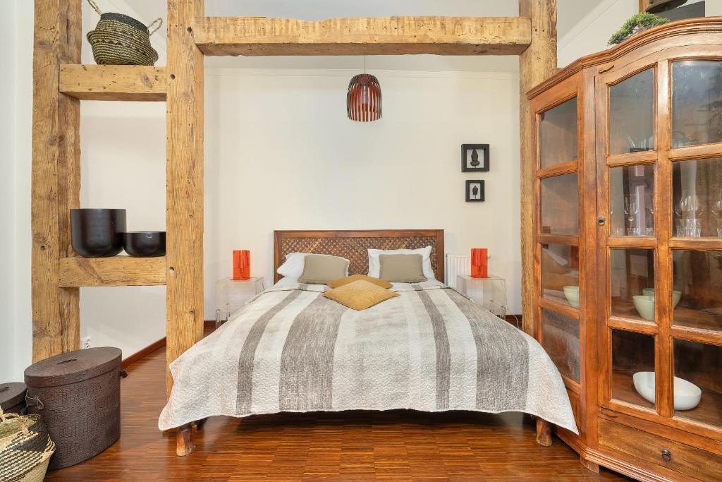 a bedroom with a bed with a striped blanket at Sunny Apartments in the Heart of Poznań Old Town by Renters in Poznań