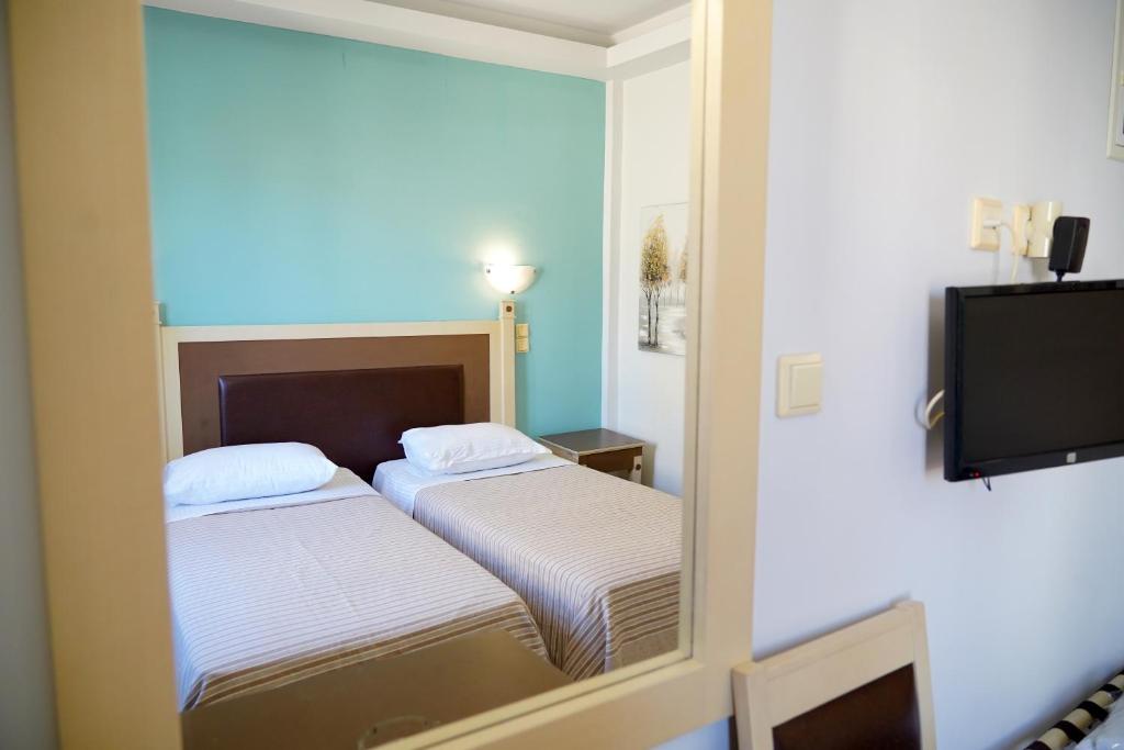 Postel nebo postele na pokoji v ubytování Hotel Selini