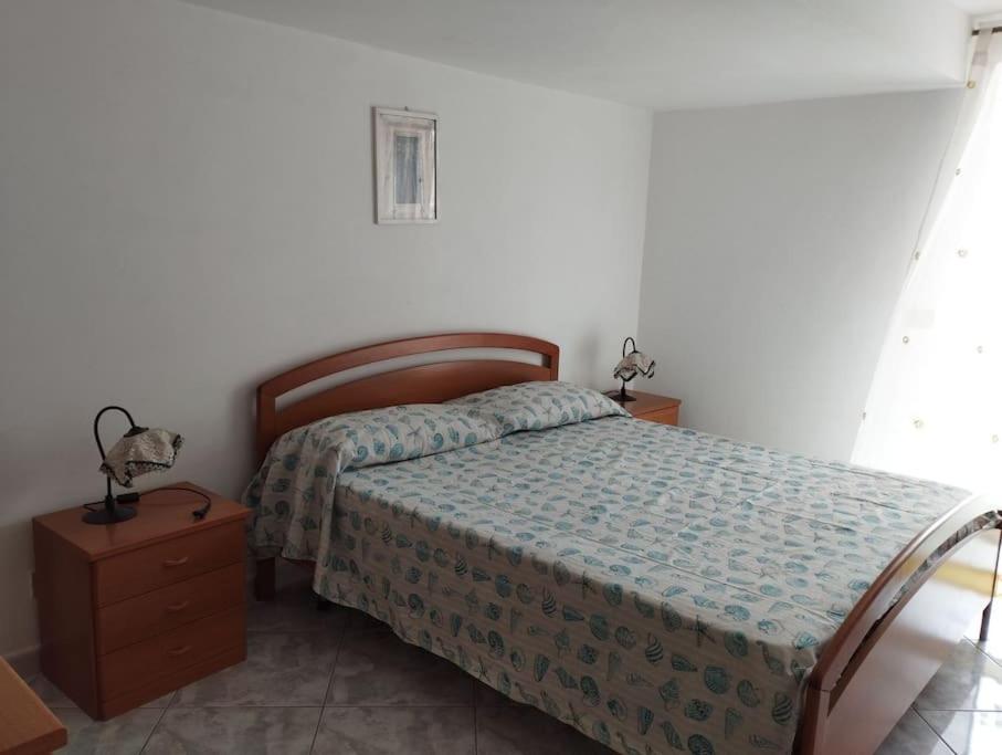 a bedroom with a bed and a nightstand and a bed sidx sidx sidx sidx at Casa Nannina in Ischia Town