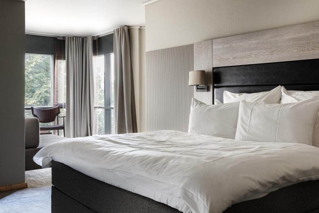 a hotel room with a large bed with white pillows at Clarion Hotel Stavanger in Stavanger