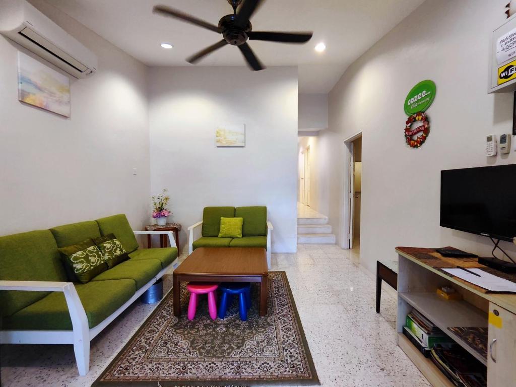 a living room with a couch and a tv at TREX_Batu Pahat Homestay in Batu Pahat