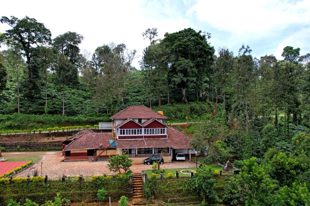 an aerial view of a house in the woods at Balekhan Homestay - Heritage & Mountain View in Chikmagalūr