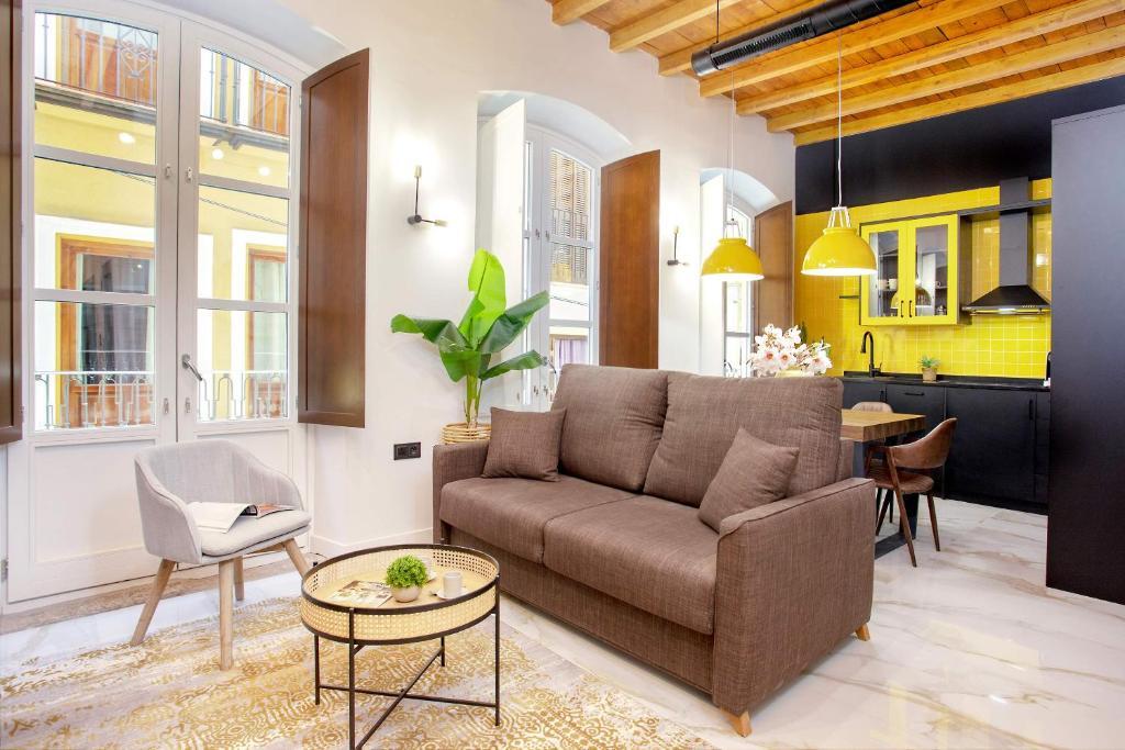 a living room with a couch and a table at Genteel Home Catedral Granada in Granada