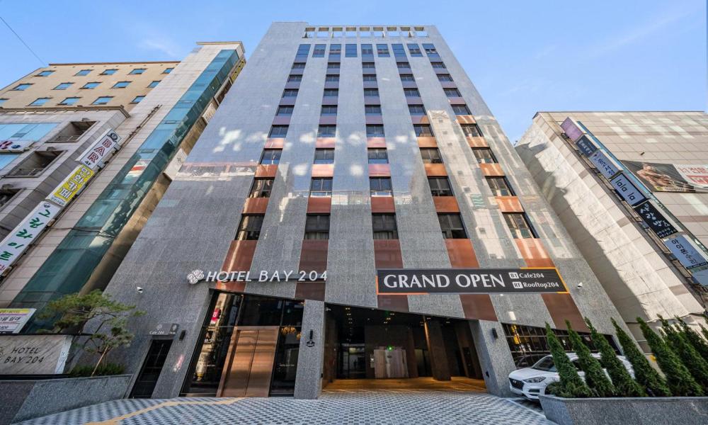 a tall building with a sign that reads grand open at Incheon Guwol Hotel Bay 204 in Incheon