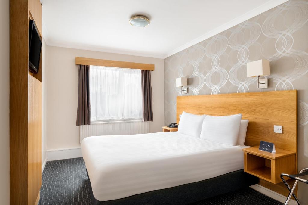 Postel nebo postele na pokoji v ubytování Rooms Inn