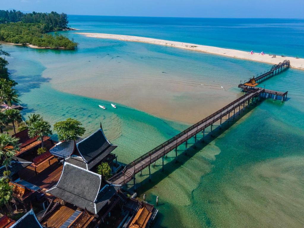 an aerial view of a pier on a beach at The Hotspring Beach Resort & Spa - SHA Extra Plus in Natai Beach