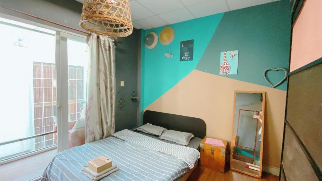 a bedroom with a bed and a large window at Happy Chubby Homestay in Ho Chi Minh City