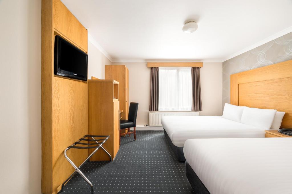 Postel nebo postele na pokoji v ubytování Rooms Inn