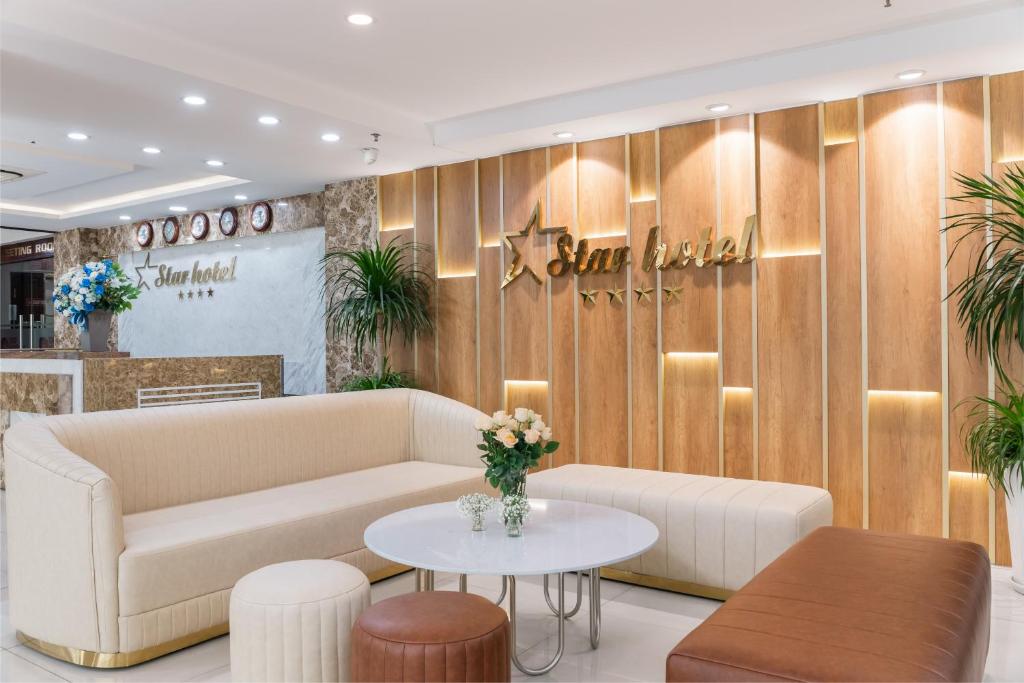 a lobby with a couch and a table at Star Hotel and Spa Danang in Danang