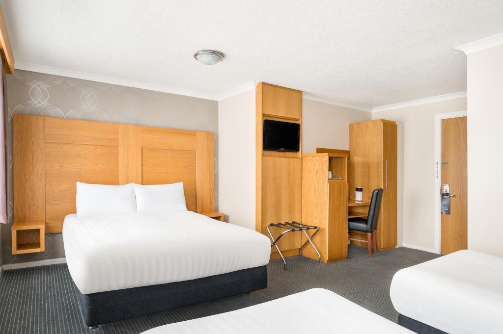 Postel nebo postele na pokoji v ubytování Rooms Inn