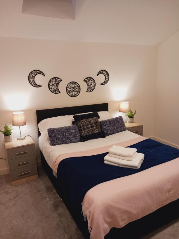 um quarto com uma cama com lençóis azuis e brancos em Bliss Apartments - Contractor 301 em Bradford
