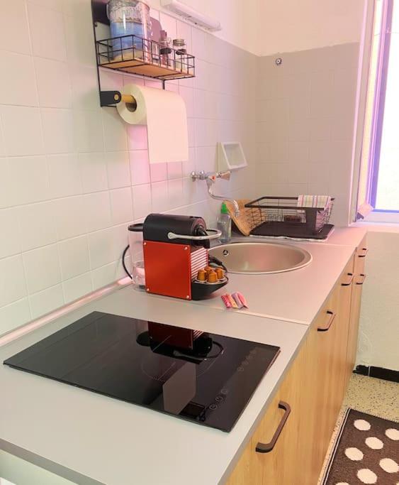 a kitchen with a sink and a counter top at À deux pas de la plage in Collioure
