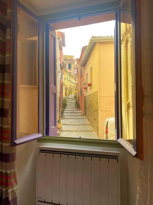 an open window with a view of a street at À deux pas de la plage in Collioure