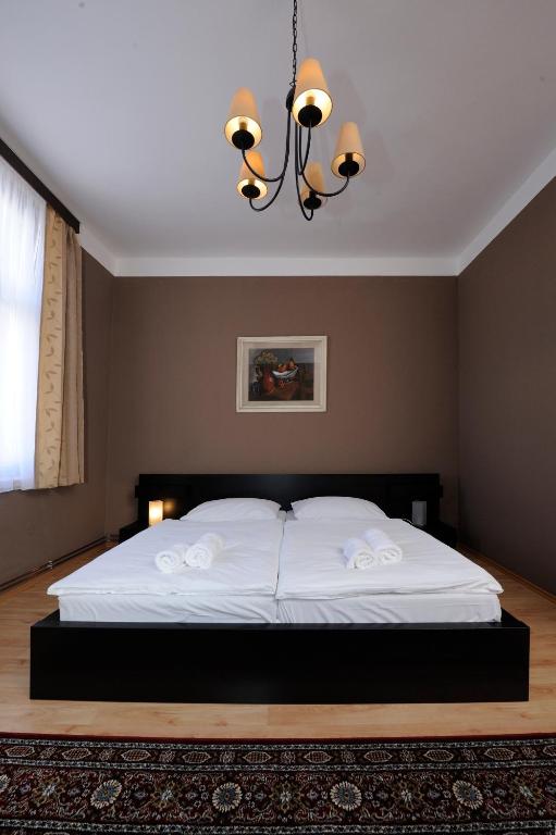Postel nebo postele na pokoji v ubytování Hotel Zlatá Štika