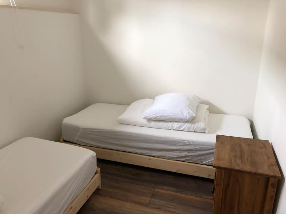 a small bedroom with a bed and a wooden table at Villa Waterwolf in Aalsmeer