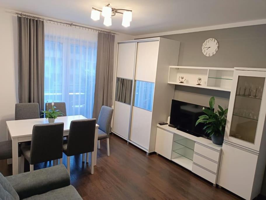 a living room with a table and a dining room at Apartament u Oli i Laury in Krakow