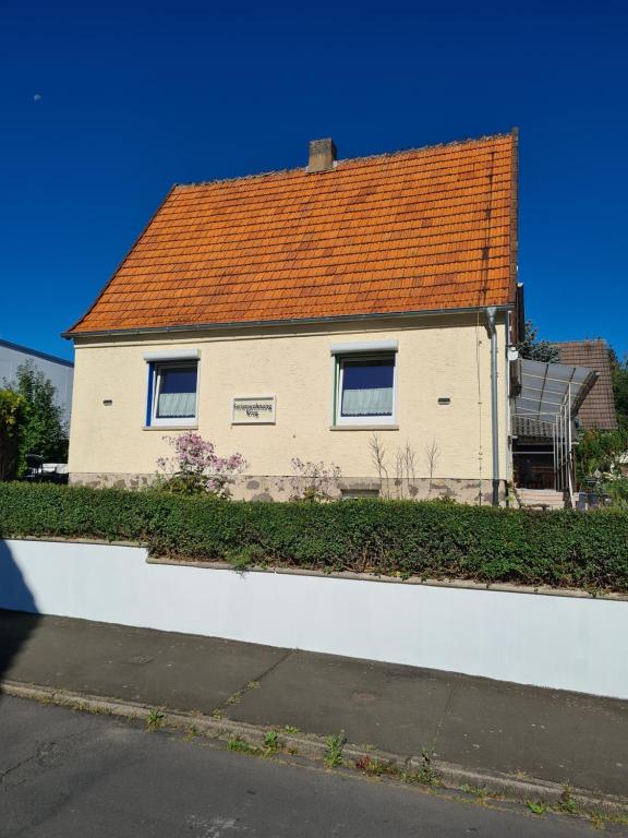 a white house with an orange roof on a street at Fe Wo Nele in Alsfeld