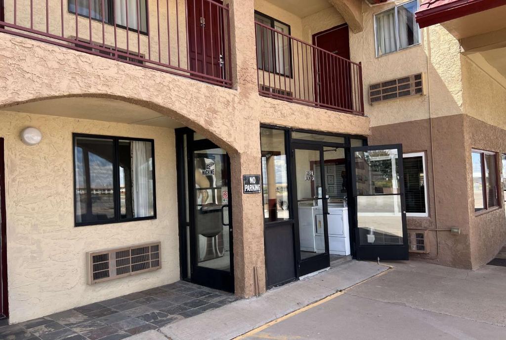 an entrance to a building with glass doors at Travelodge by Wyndham Holbrook in Holbrook