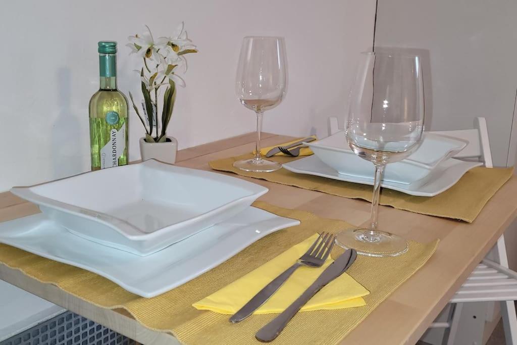 a table with two white plates and wine glasses at Villa Blanca, W-Lan, Office in Leverkusen