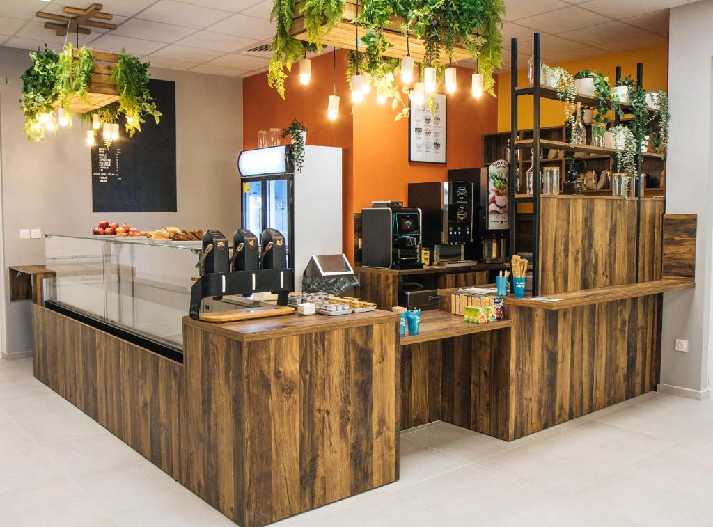 a coffee shop with wooden walls and a counter at Twenty Business Flats Béziers in Béziers