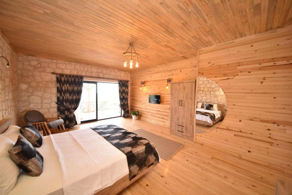 a bedroom with a bed in a wooden room at KYANEAİ VİLLA in Demre