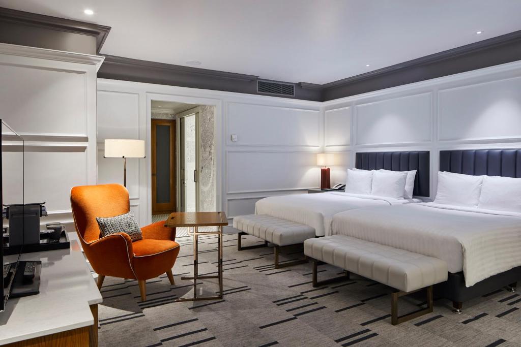 a hotel room with a large bed and a chair at London Marriott Hotel County Hall in London