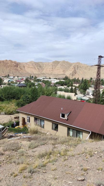 a house with a red roof in the desert at GreenHouse in Naryn