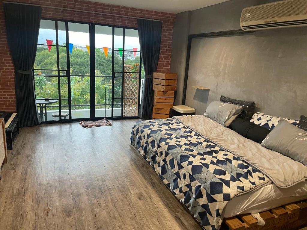 a bedroom with a bed and a large window at 420 Canopy Studio Meals Included in Chiang Mai
