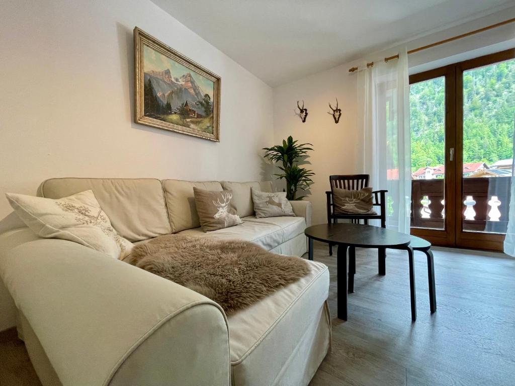 a living room with a couch and a table at Ferienwohnung Almblick in Reit im Winkl