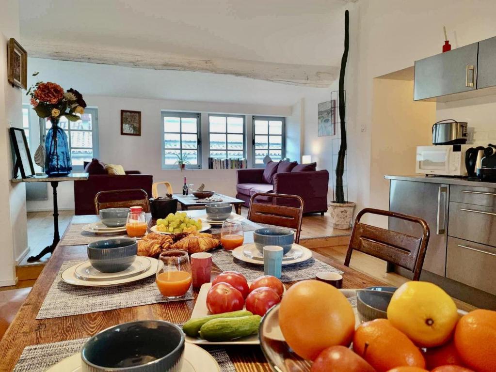 - une table avec des fruits et des légumes dans le salon dans l'établissement Loft Chic Verdun / ConciergerieDameCarcas, à Carcassonne