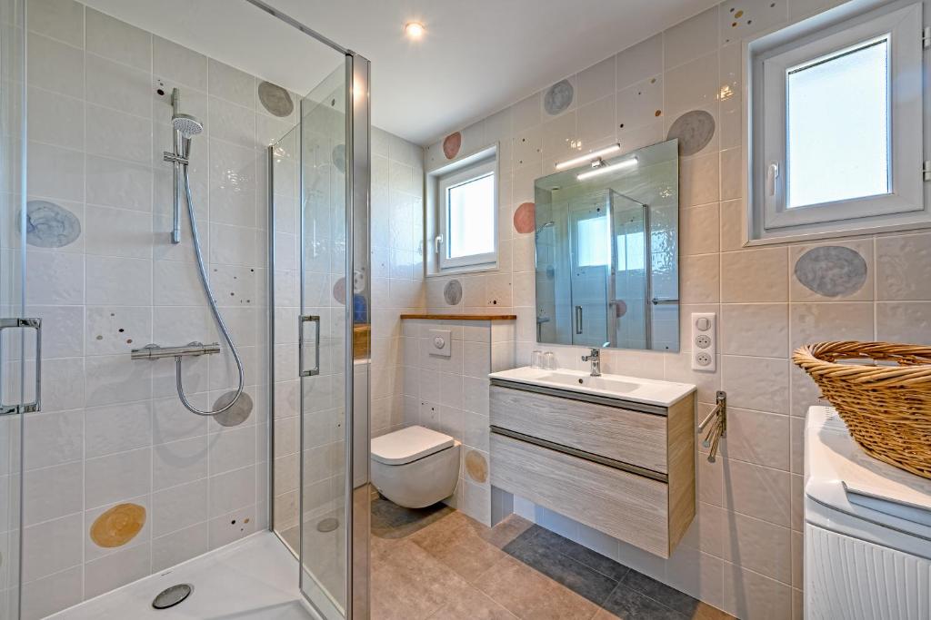 a bathroom with a shower and a sink and a toilet at Beach House 1km de la plage in Audierne