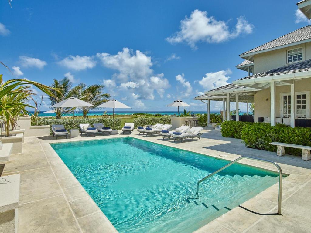 a swimming pool in the backyard of a house at Larimar - Luxury Ocean Front Villa in Saint Philip