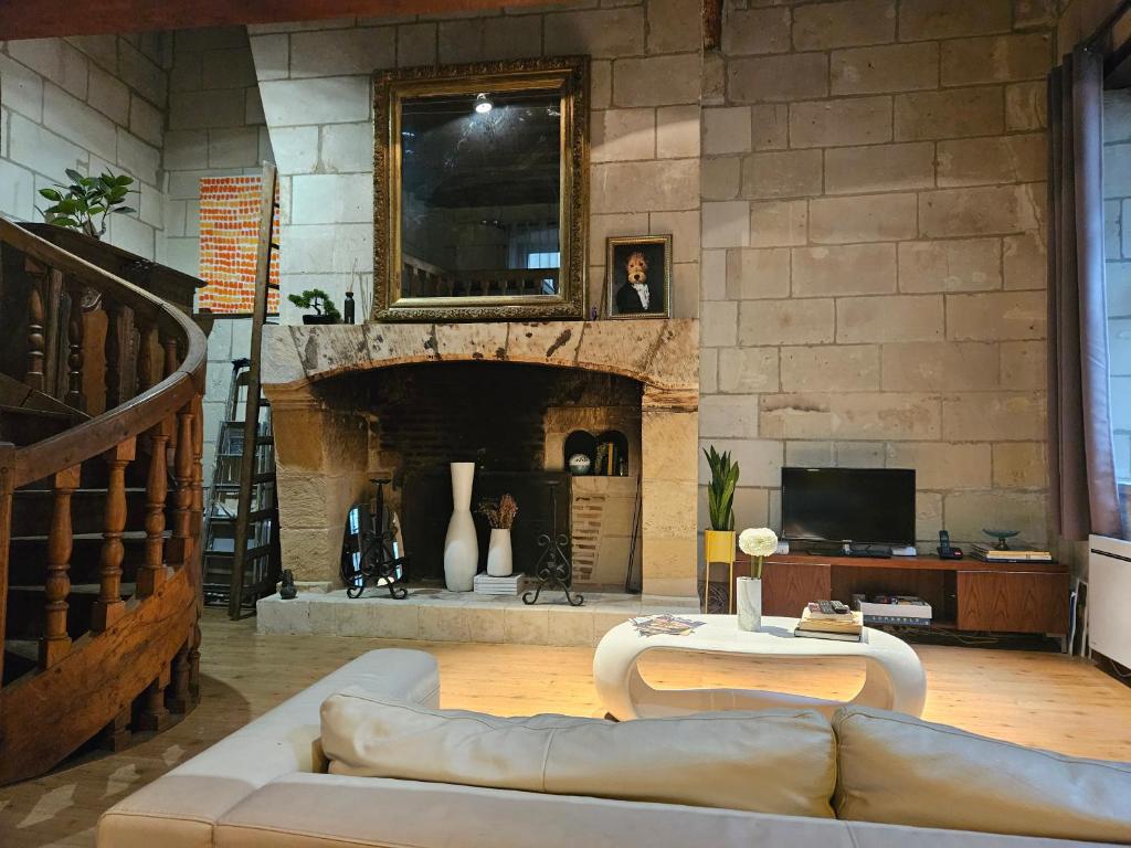 a living room with a couch and a fireplace at Hotel Robin Quantin in the heart of Old Tours in Tours