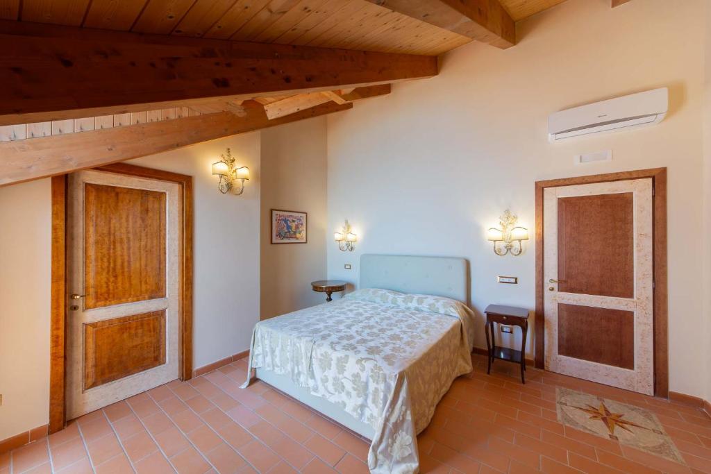 a bedroom with a bed and a table and a door at Villa Isabella Minori in Minori