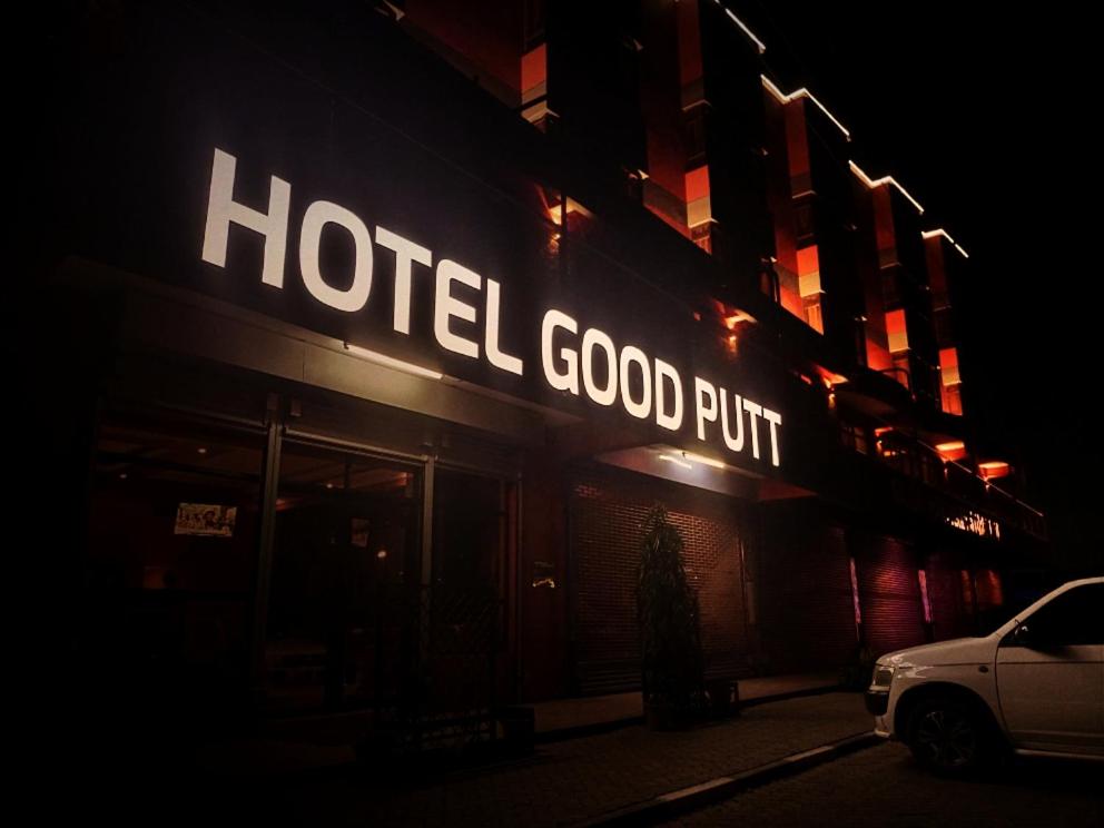 a hotel good put sign on a building at night at Hotel Good Putt in Nakuru