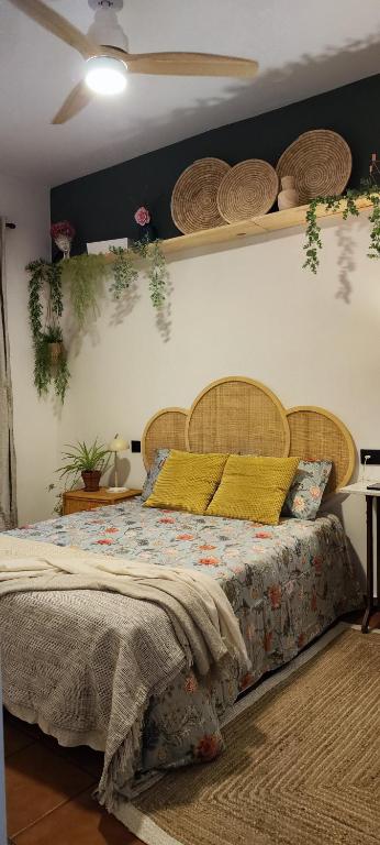 a bedroom with a bed and shelves on the wall at El 6 De Busquet in Cáceres