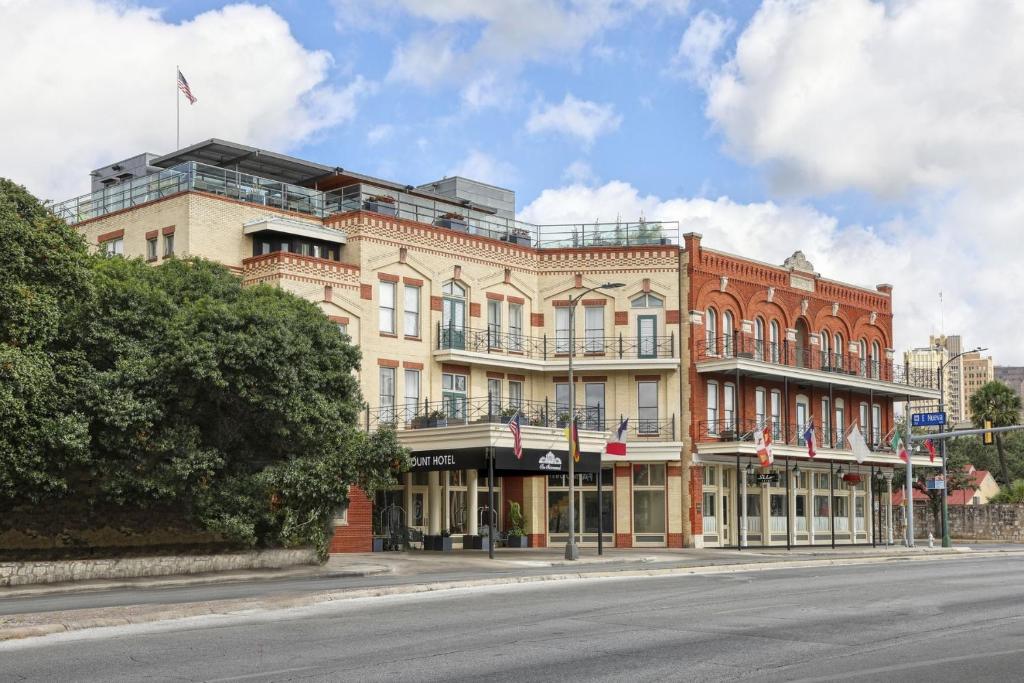 a large brick building on the corner of a street at Fairmount Hotel in San Antonio