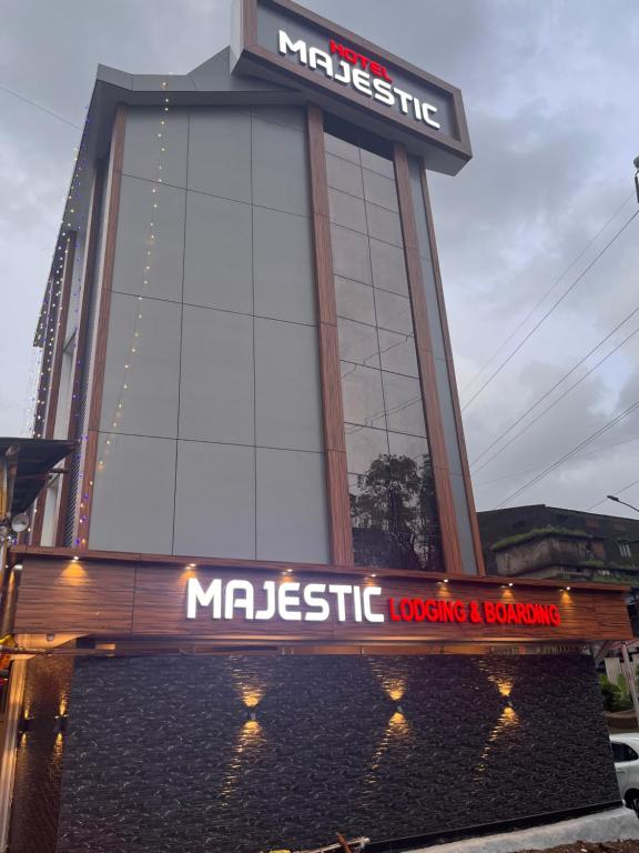 a large building with a sign on top of it at Hotel Majestic in Ulhasnagar