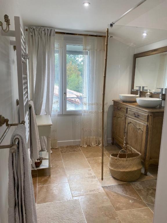 a bathroom with a sink and a mirror at Maison d hôtes Les Chantours dans réserve naturelle 15 hectares in Saint-Antoine-Cumond