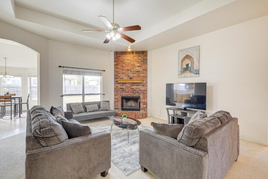 a living room with two couches and a fireplace at Lovely Killeen Retreat with Brick Fireplace! in Killeen