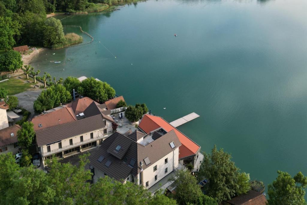 an aerial view of a house by a lake at La Villa du Lac in Aiguebelette-le-Lac