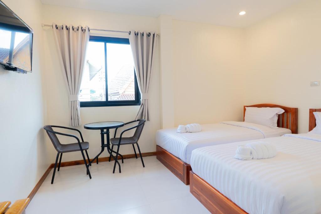 Postel nebo postele na pokoji v ubytování Chotika Hotel โรงแรมโชติกา ณ เชียงคาน