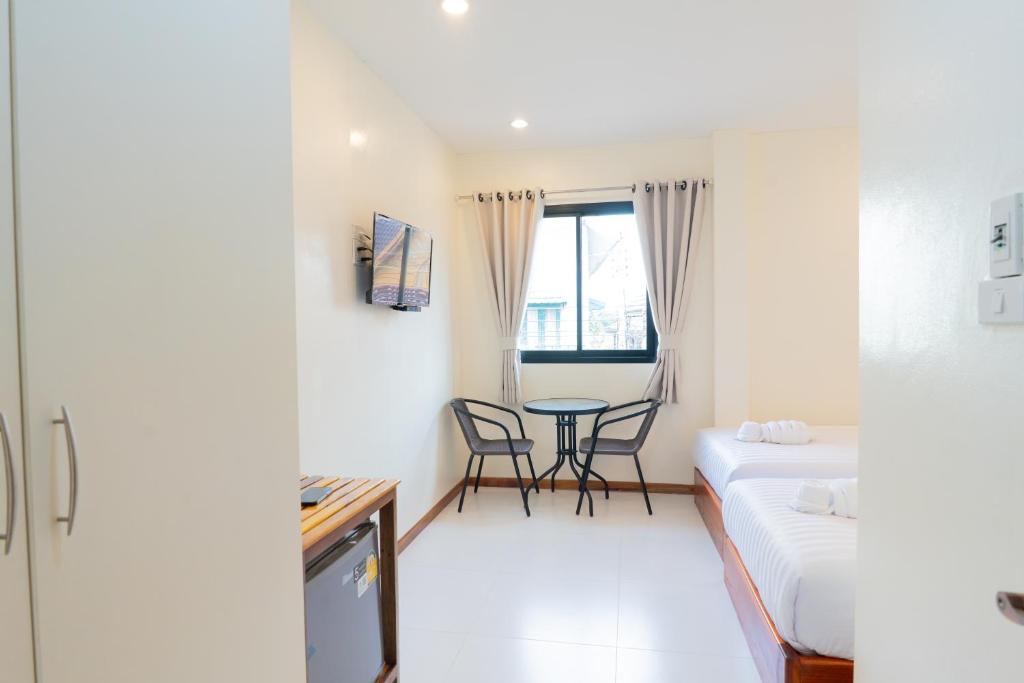 Postel nebo postele na pokoji v ubytování Chotika Hotel โรงแรมโชติกา ณ เชียงคาน